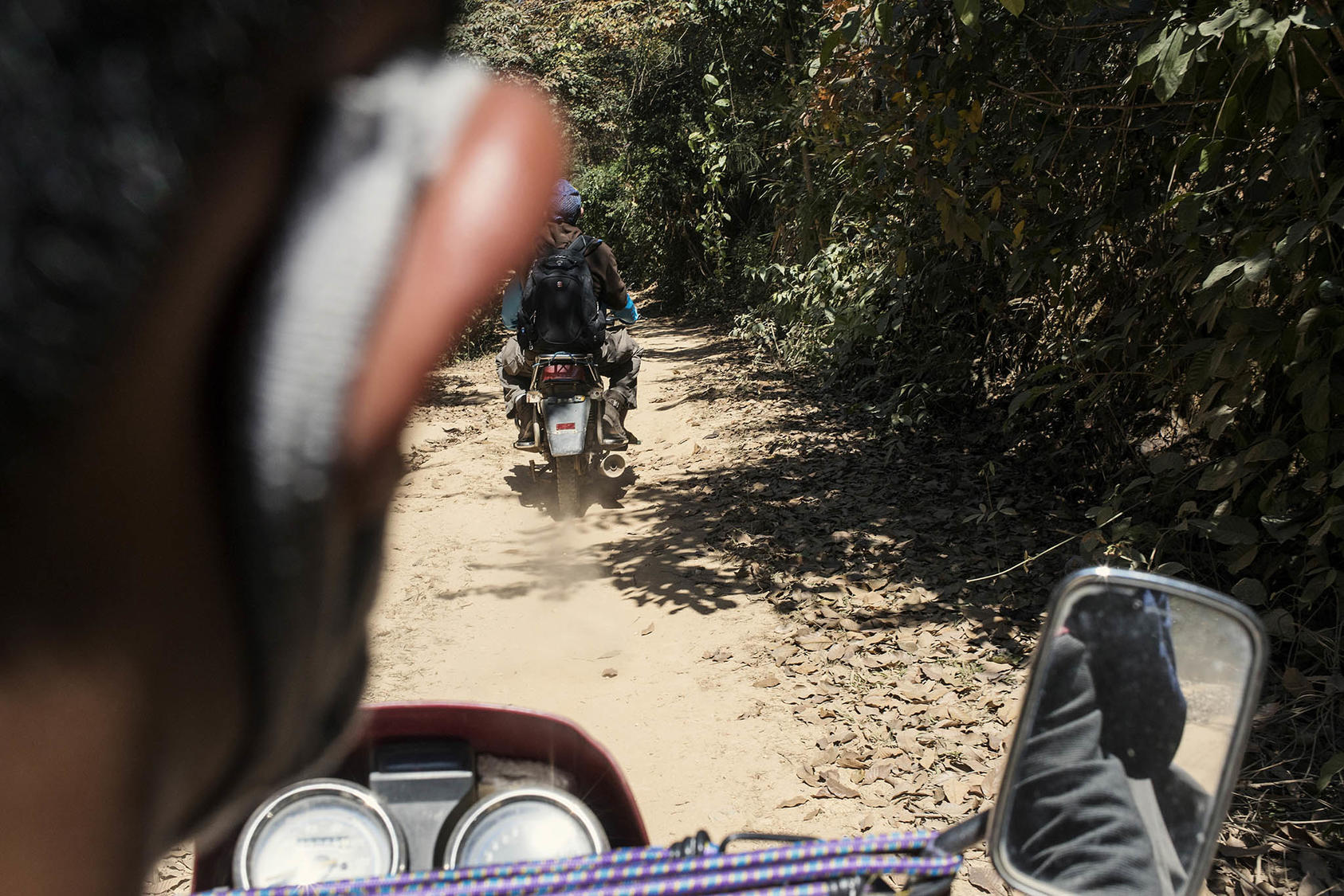 Chinese visitors are taken into Myanmar by motorbikes to avoid Chinese border controls near Mong La, Myanmar, Feb. 6, 2014. Since Myanmar’s 2021 coup, illegal activity across the border has skyrocketed. (Gilles Sabrie/The New York Times)