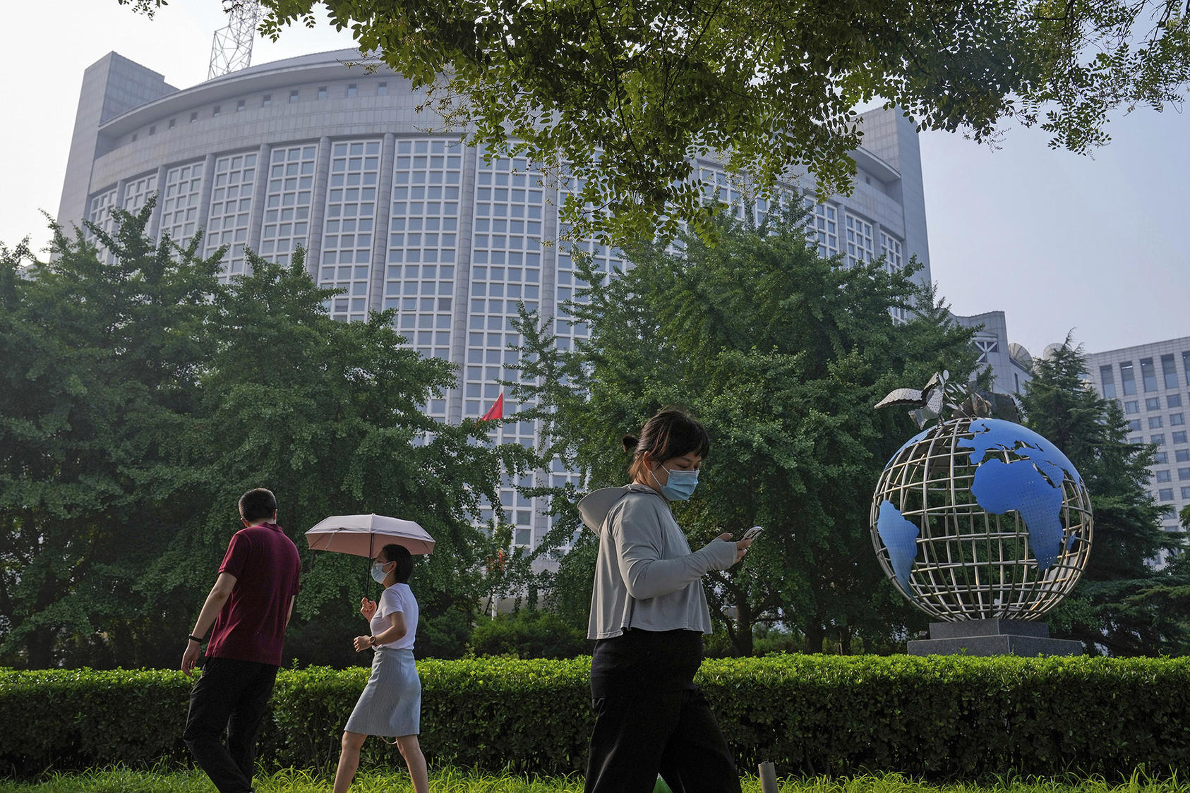 A globe sculpture is displayed outside the Ministry of Foreign Affairs office in Beijing on August 3, 2022. For a decade or more, the People’s Republic of China has shown a growing interest in playing a larger role in preventing and mitigating regional conflict and instability. (Photo by Andy Wong/AP)