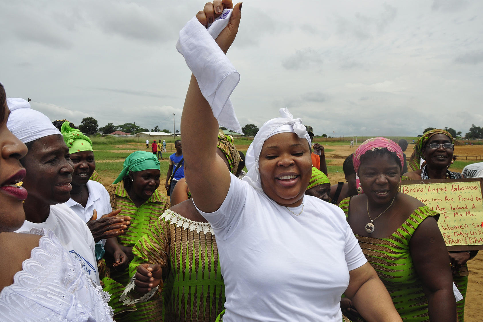 Leymah Gbowee, center, reacts to winning the Nobel Peace Prize in Monrovia, Liberia, on October 9, 2011. Gbowee was honored for organizing Christian and Muslim women to bring peace to Liberia and women’s participation in elections. (Photo by Abbas Dulleh/AP)