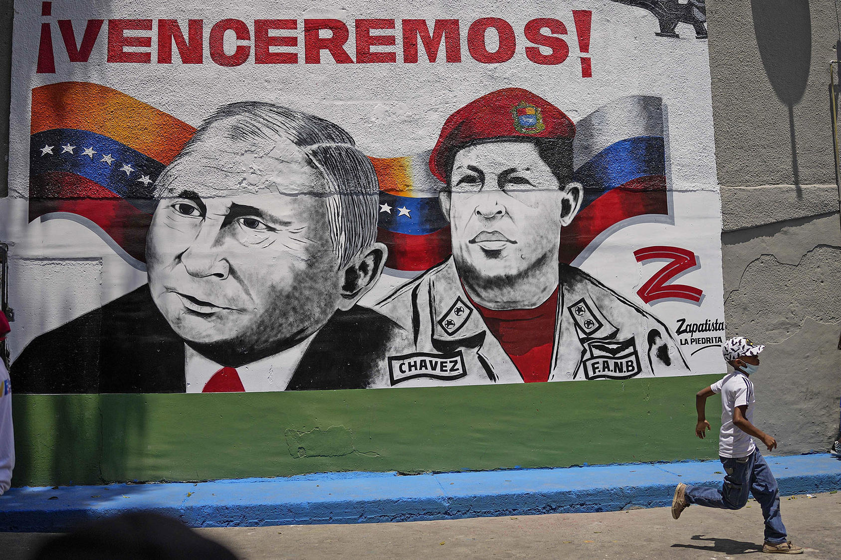 A mural of Russian president Vladimir Putin and late Venezuelan president Hugo Chavez is seen in Caracas, Venezuela, on April 2, 2022. (Photo by Matias Delacroix/AP)