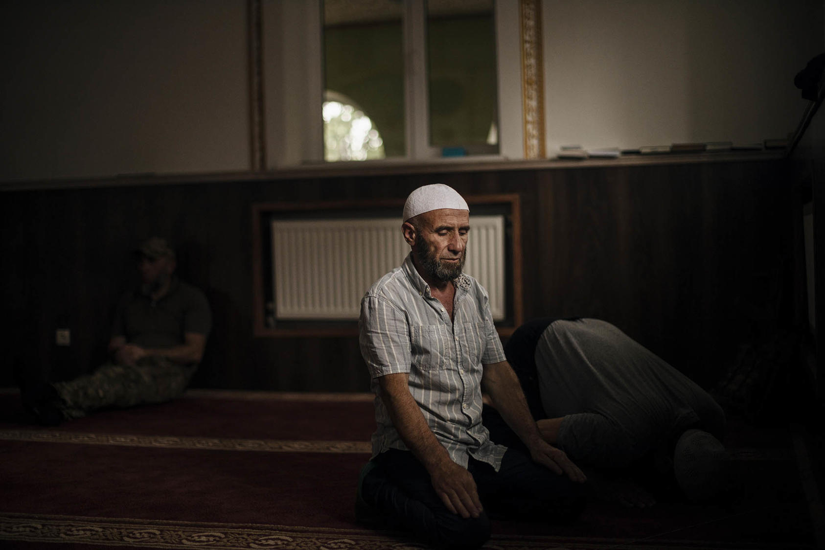 A man praying inside the last working mosque in Donetsk Province, Ukraine, amid Russia’s invasion. August 11, 2023. (Diego Ibarra Sanchez/The New York Times)