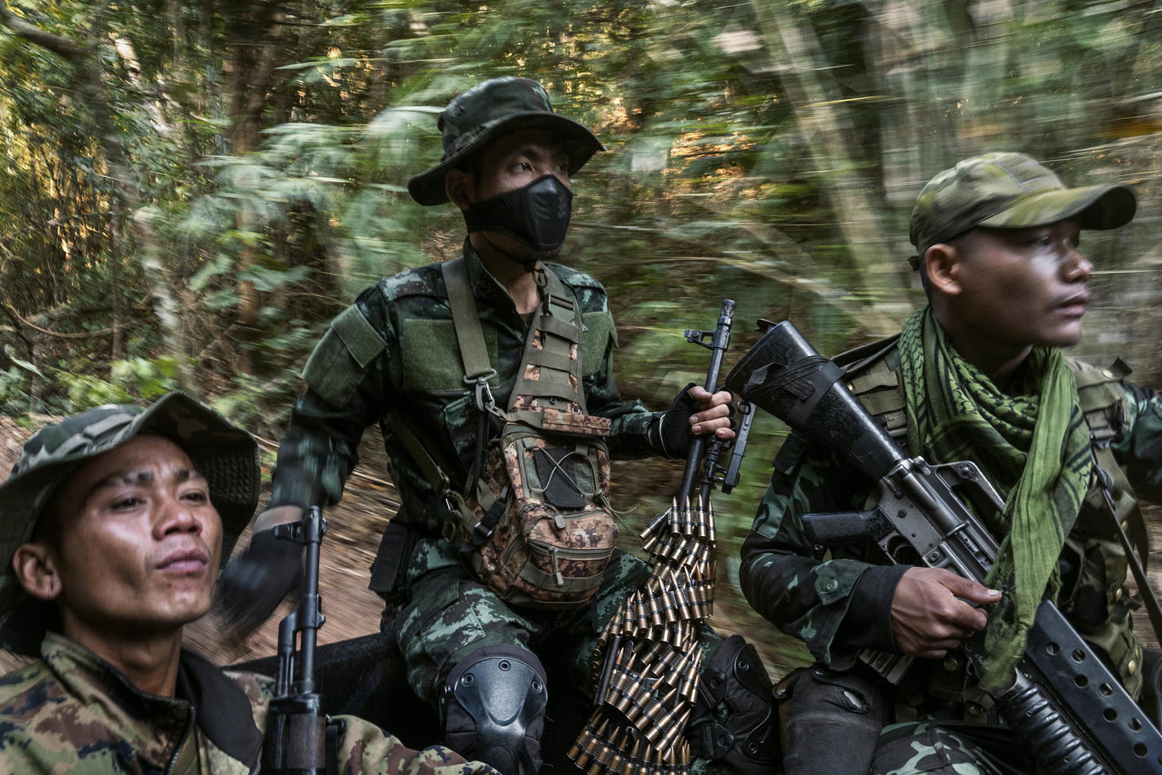 Members of an ethnic militia in the back of a pickup truck patrol a frontline area near government military positions in Myanmar’s Kayin State on March 9, 2022. (Adam Dean/The New York Times)