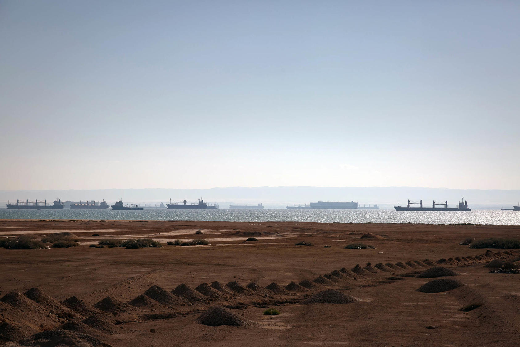 Cargo ships waited in the Red Sea near the opening of the Suez Canal on March 29, 2021. Recent attacks by Houthi rebels on ships in the Red Sea have disrupted global supply chains. (Sima Diab/The New York Times)