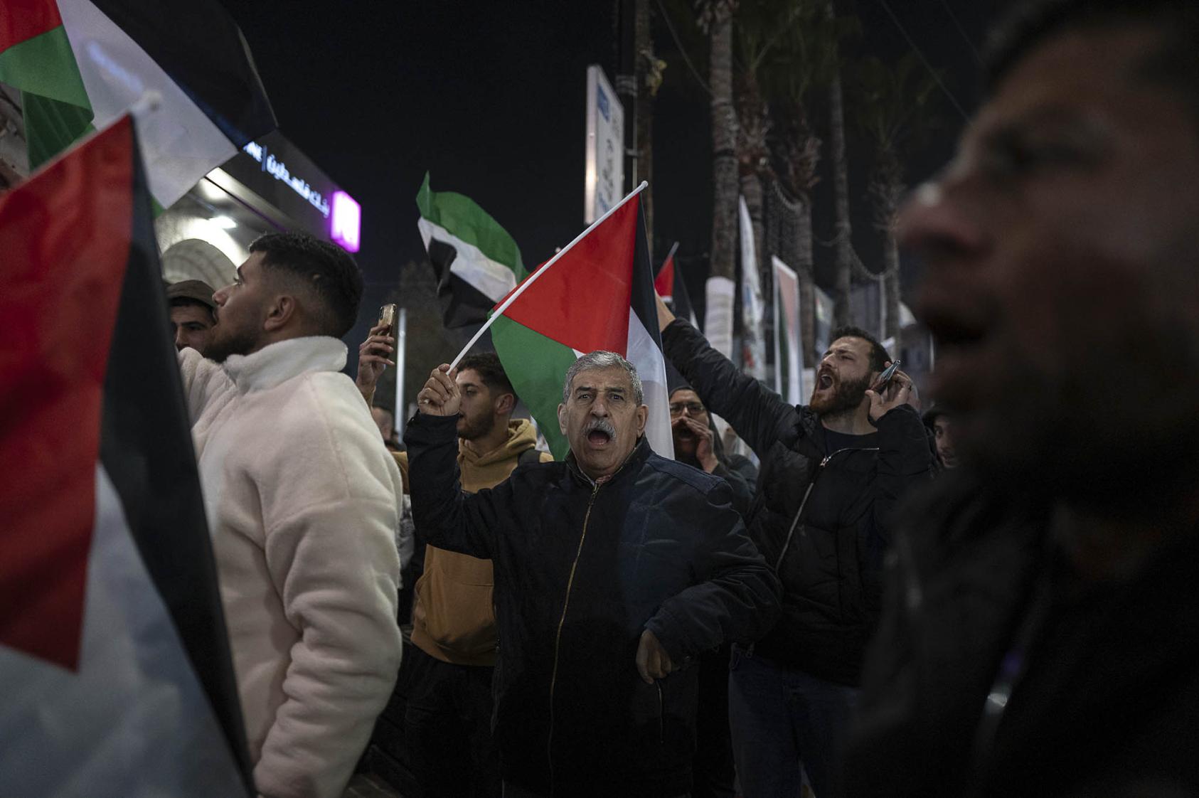 People wave Palestinian flags while celebrating the announcement of a cease-fire in Ramallah in the West Bank, on Wednesday, Jan. 15, 2025. (Afif Amireh/The New York Times)