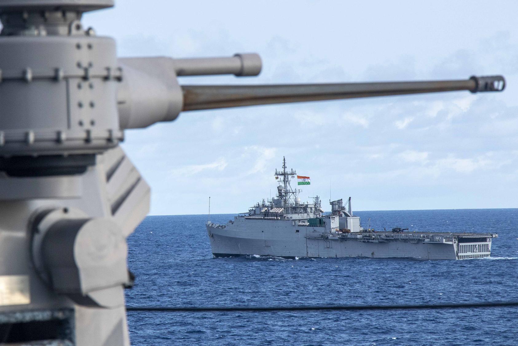 An Indian Navy amphibious transport dock sails alongside the Whidbey Island-class dock landing ship USS Comstock (LSD 45) in the Bay of Bengal during Tiger Triumph 2025, April 8. (U.S. Navy/Chief Mass Communication Specialist Leonard Adams)
