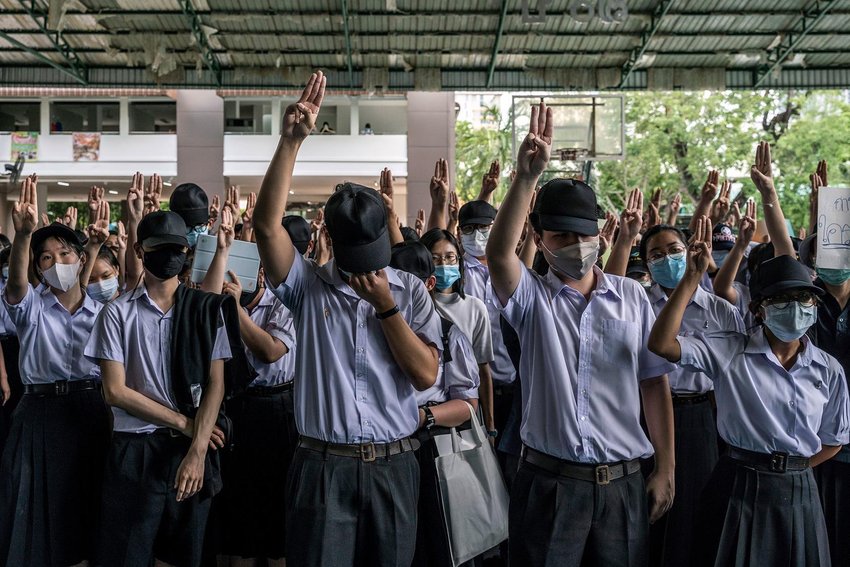 At a protest in Bangkok on July 31, 2020, students flash a three-fingered salute from the "Hunger Games" movies that has become a symbol of antigovernment defiance in Thailand. (Adam Dean/The New York Times)