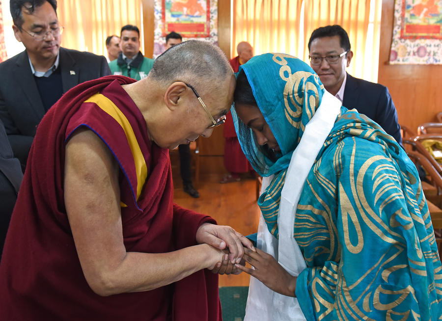 His Holiness the Dalai Lama here with Darine, a young Sudanese physician working with communities of people displaced by warfare in her country