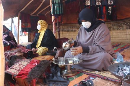 Women display handicrafts and prepare tea at the ceremony in September for the opening of the new market in Ubari.