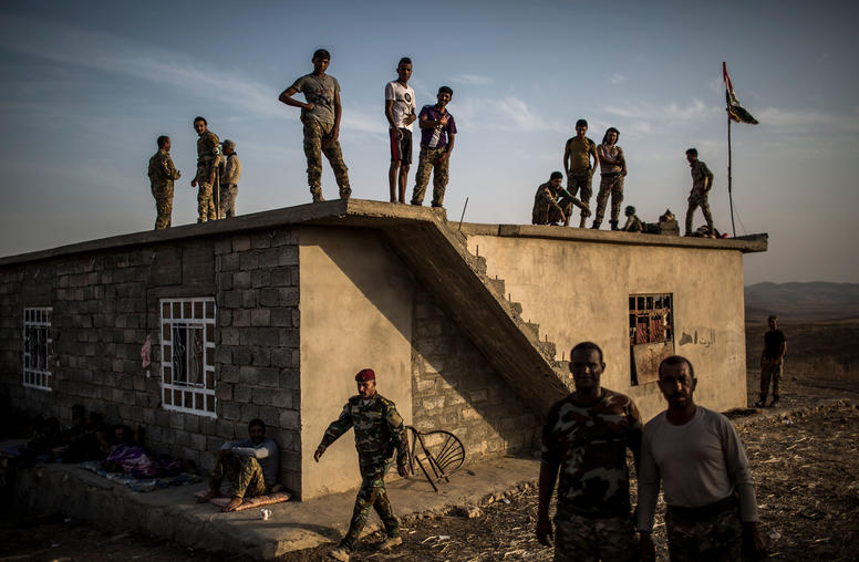 Fighters, who joined a militia to help liberate the city of Mosul from the Islamic State, wait at their base near the Mosul Dam near Karaj, Iraq, Oct. 18, 2016. (Bryan Denton/The New York Times)