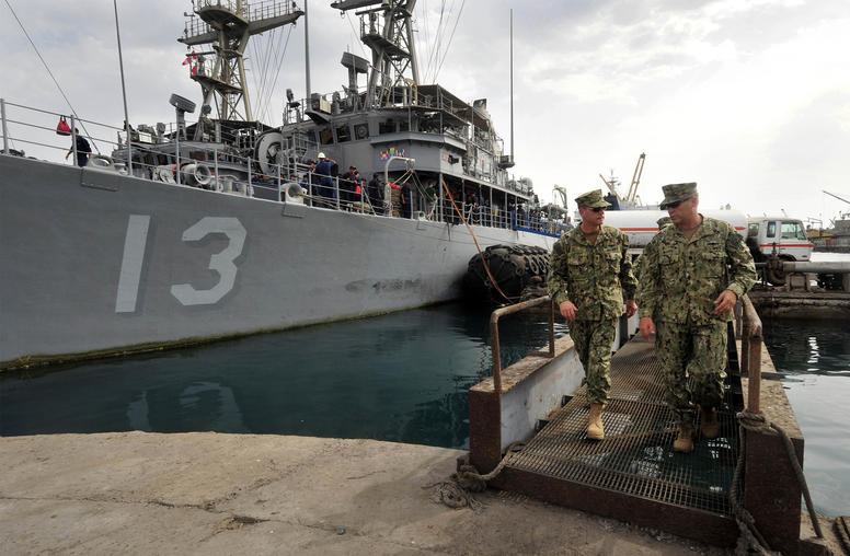 Rear Adm. John Scorby, then-commander of Navy Region Europe, Africa, Southwest Asia, left, speaks with Cmdr. Jeffrey Marty, right, during a brief of port operations in the port of Djibouti on May 19, 2015. (Photo: U.S. Navy)