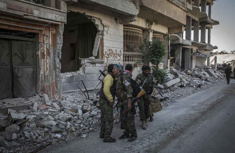 A police officer mans a checkpoint in Raqqa, Syria, on June 13, 2018. Despite the liberation of Raqqa from ISIS, the group remains a potent threat. (Ivor Prickett/The New York Times)