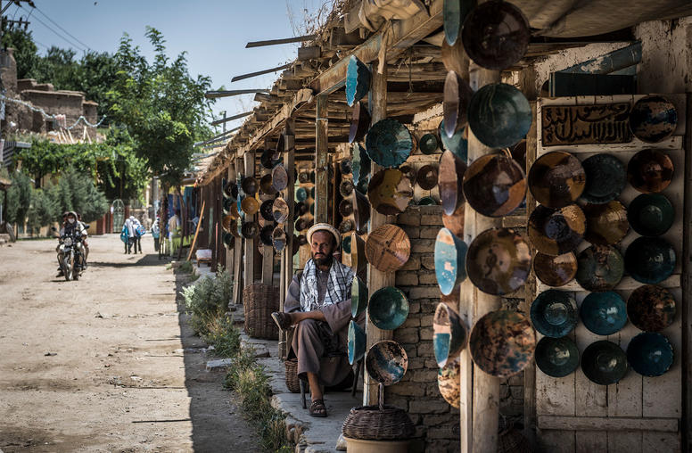 Shops on the main street through Istalif, Afghanistan, where they make distinctive turquoise pottery, June 30, 2016. (Sergey Ponomarev/The New York Times)