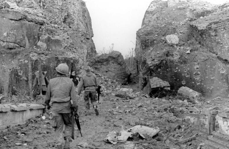 U.S. troops patrol along the shattered ancient walls of the Vietnamese city of Huế during the North Vietnamese 1968 Tet Offensive. That campaign was the bloodiest phase of two decades of war in Vietnam. (U.S. Army)