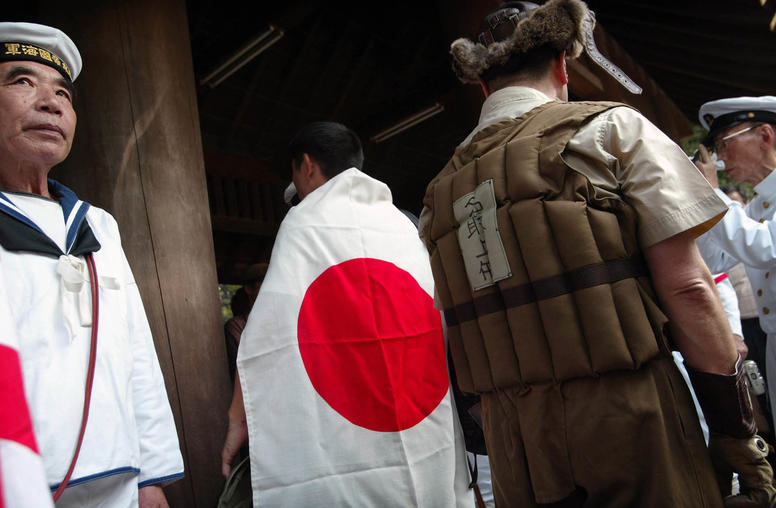 Veterans and youths wearing Imperial-era military uniforms march into the Yakusuni Shrine, the Shinto memorial where Class A war criminals are enshrined along with the war dead, in Tokyo on Monday, Aug. 15, 2005. (Ko Sasaki/The New York Times)