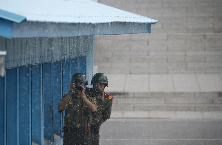 North Korean soldiers keep watch during a ceremony for the anniversary of the signing of the Korean War armistice agreement at the truce village of Panmunjom, South Korea, on July 27, 2016. (Kim Hong-Ji/Pool via The New York Times)