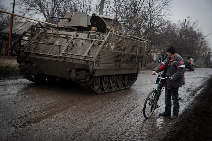 An armored vehicle distributing food and medicine to residents in Ocheretyne, Ukraine, at town with refugees from nearby Avdiivka, Feb. 13, 2024. (Tyler Hicks/The New York Times)