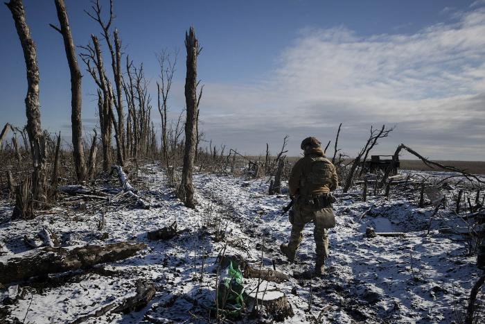 A Ukrainian soldier patrols outside Bakhmut, eastern Ukraine, in January. Ukrainian forces have been rationing short supplies of ammunition while awaiting the U.S. renewal of aid for their defense. (Tyler Hicks/The New York Times)
