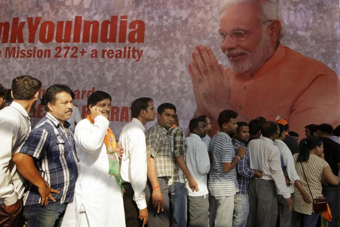 Bharatiya Janata Party supporters wait in line for free T-shirts to celebrate the landslide election victory of Narendra Modi, in New Delhi, India, May 16, 2014. (Kuni Takahashi/The New York Times)