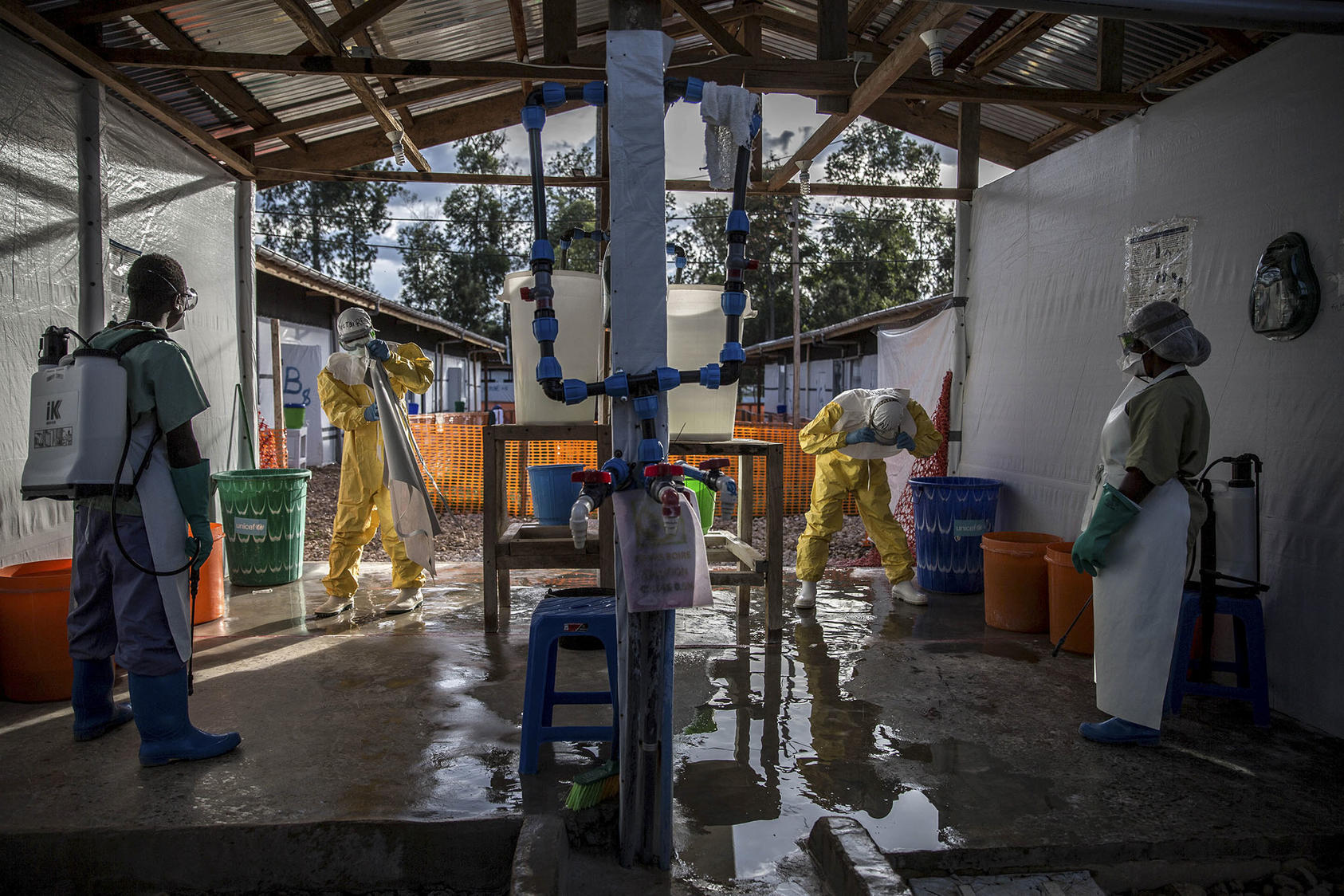 Ebola responders go through decontamination at a treatment center in Katwa, Congo, May 14, 2019. (Finbarr O'Reilly/The New York Times)