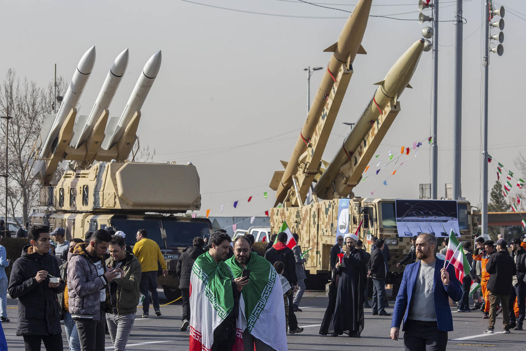 Citizens walk near missile carriers and other weapons displayed during an event marking the 45th anniversary of Iran’s Islamic Revolution in Tehran, Iran, on Sunday, Feb. 11, 2024. (Arash Khamooshi/The New York Times)