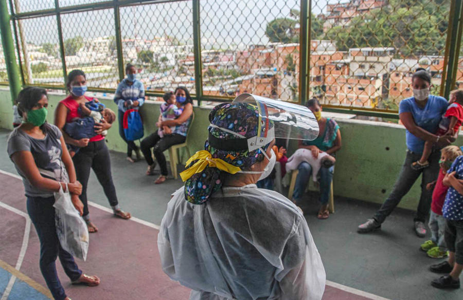 Maria meets mothers in Petare, a poor neighborhood in Caracas, to discuss ways to prevent the spread of COVID. In her visits, she also discusses ways to prevent violence, using peacebuilding tools from her USIP training. (Maria)